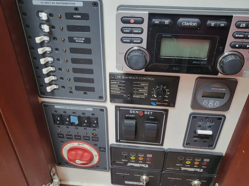 Slide: The Image of Control panel of a 2012 Crusader Boats outboard cruiser with various switches and displays. - 24