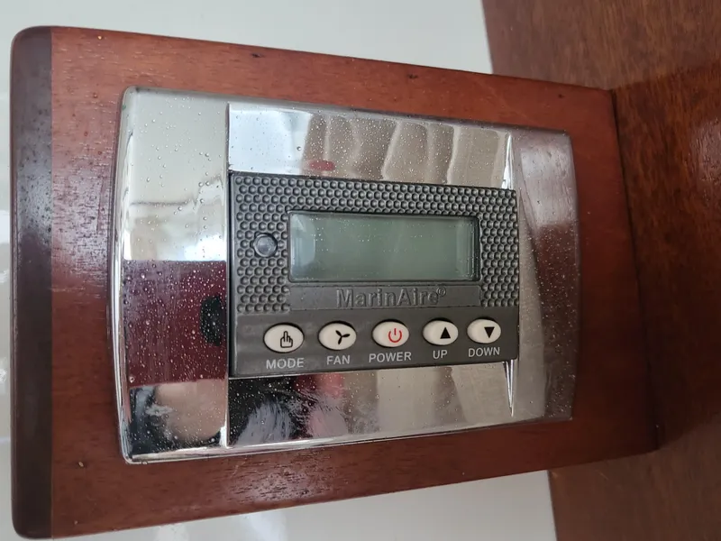 Slide: The Image of Control panel on a 2012 Crusader Boats outboard cruiser, featuring a digital display and buttons. - 25