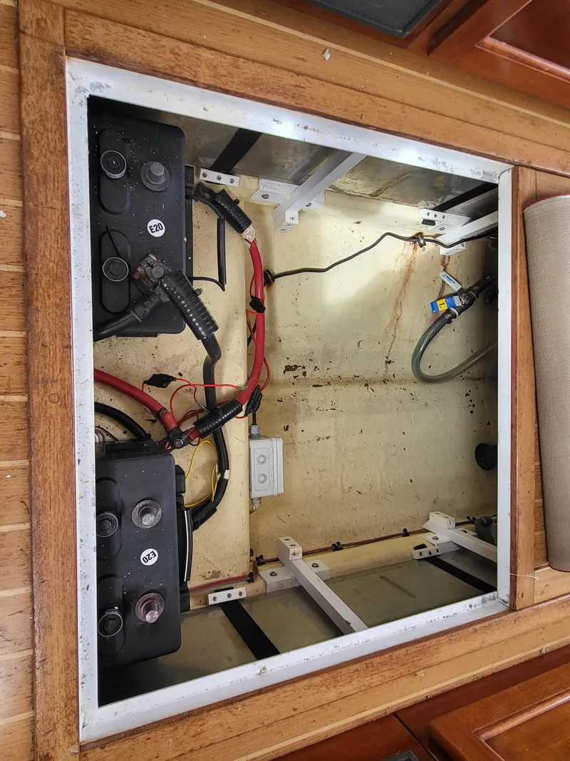 Slide: The Image of Battery compartment of a 2012 Crusader Boats outboard cruiser, showing wiring and connections. - 28