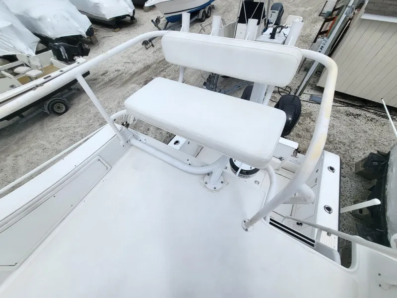 Slide: The Image of 2012 Crusader Boats outboard cruiser with white seating and railing, docked in a marina. - 35