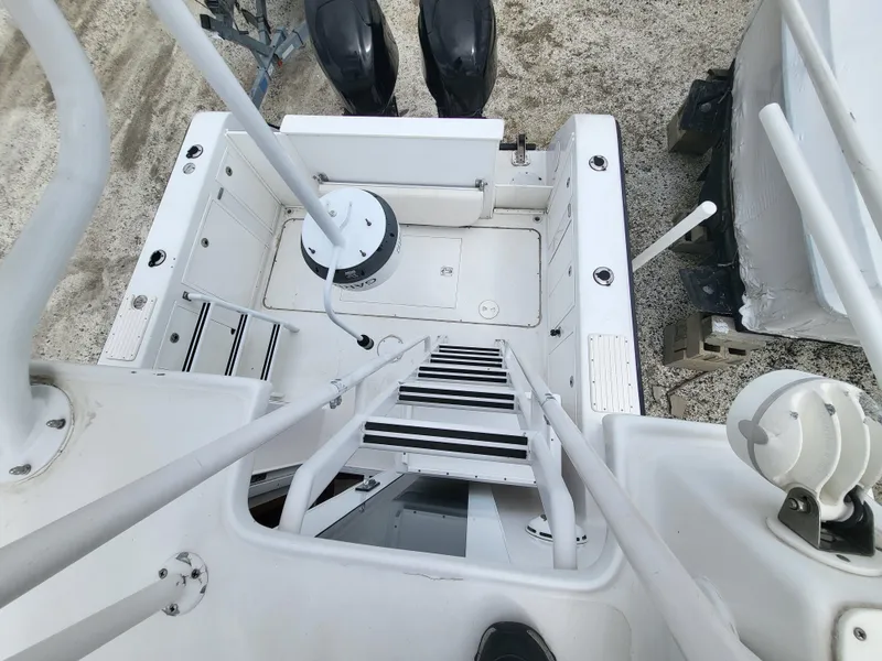 Slide: The Image of 2012 Crusader Boats outboard cruiser deck with ladder and dual engines. - 36