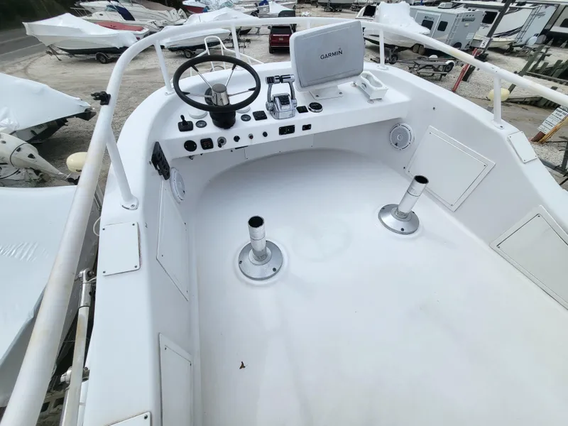 Slide: The Image of 2012 Crusader Boats outboard cruiser cockpit with steering wheel and Garmin navigation system. - 37