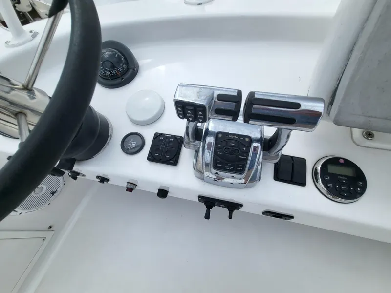 Slide: The Image of Control panel of a 2012 Crusader Boats outboard cruiser with steering wheel and throttle controls. - 38