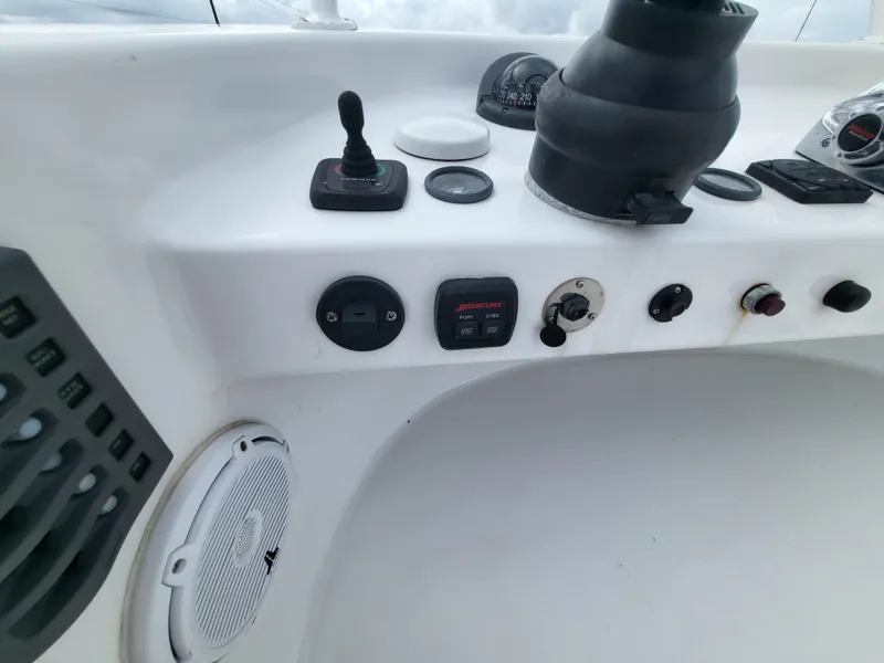Slide: The Image of Control panel of a 2012 Crusader Boats outboard cruiser with various switches and gauges. - 39