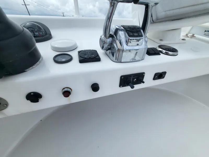 Slide: The Image of Control panel of a 2012 Crusader Boats outboard cruiser with various switches and gauges. - 40
