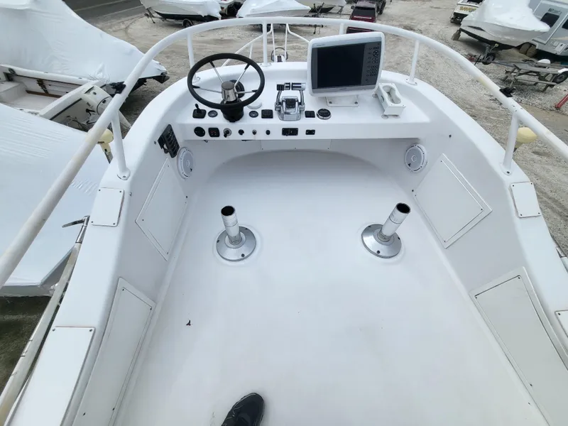 Slide: The Image of 2012 Crusader Boats outboard cruiser cockpit with steering wheel and navigation equipment. - 42