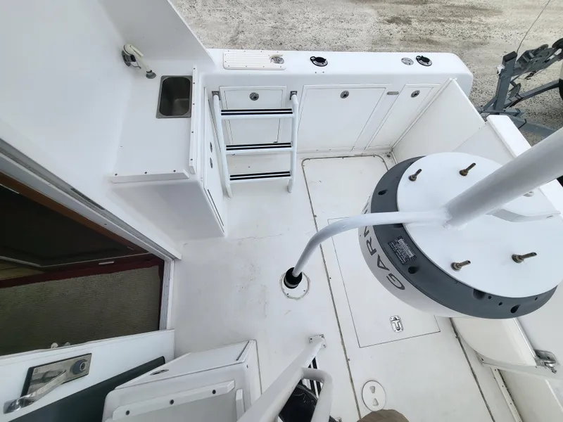 Slide: The Image of 2012 Crusader Boats outboard cruiser deck with storage, sink, and fishing rod holders. - 44