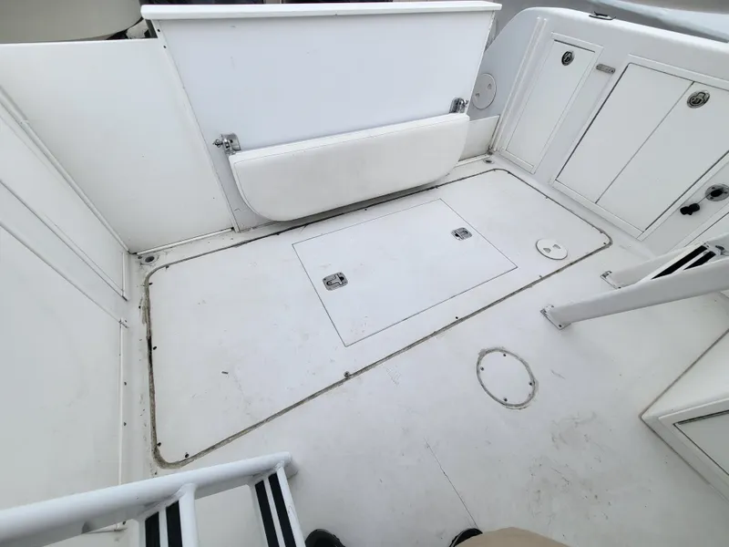 Slide: The Image of 2012 Crusader Boats outboard cruiser interior with white deck and storage compartments. - 45