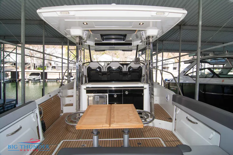 Slide: The Image of 2024 Jeanneau Leader 10.5 WA boat interior with seating and table. - 13