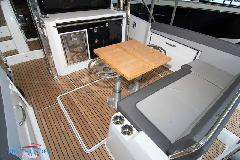 Slide: The Image of 2024 Jeanneau Leader 10.5 WA boat interior with seating, table, and kitchenette. - 15