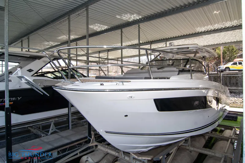 Slide: The Image of 2024 Jeanneau Leader 10.5 WA boat in covered storage. - 2