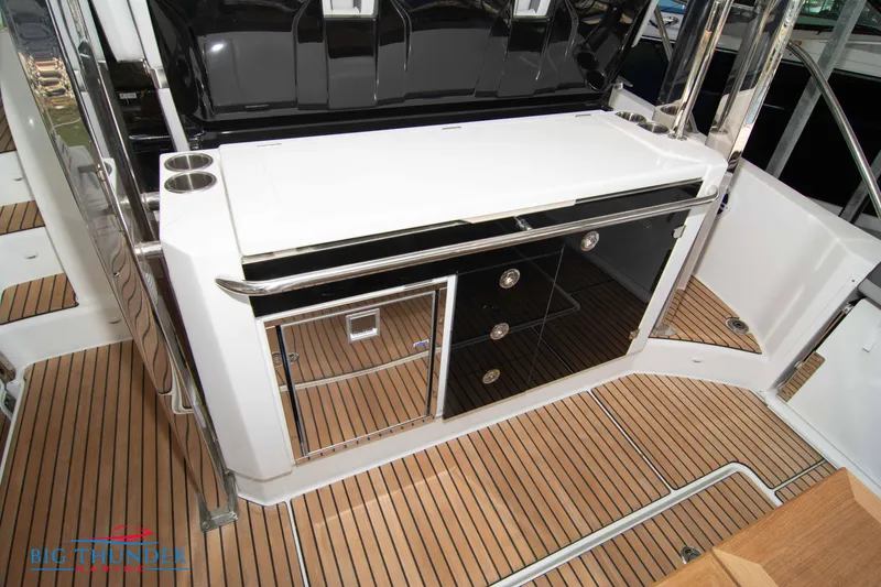 Slide: The Image of 2024 Jeanneau Leader 10.5 WA boat interior with sleek cabinetry and teak flooring. - 24