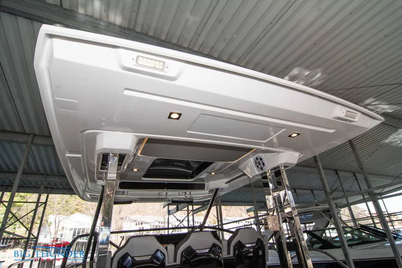 Slide: The Image of 2024 Jeanneau Leader 10.5 WA boat under a covered dock. - 28