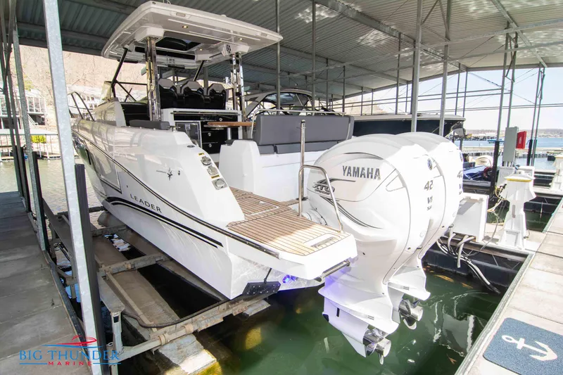 Slide: The Image of 2024 Jeanneau Leader 10.5 WA with twin Yamaha engines docked in marina. - 3