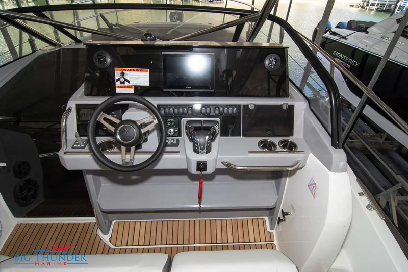 Slide: The Image of 2024 Jeanneau Leader 10.5 WA boat cockpit with steering wheel and control panel. - 30