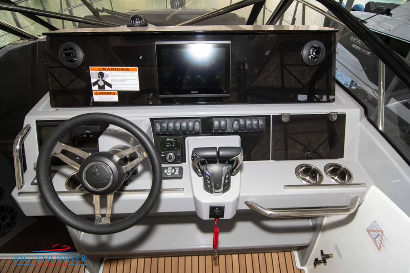 Slide: The Image of 2024 Jeanneau Leader 10.5 WA helm station with steering wheel and control panel. - 31
