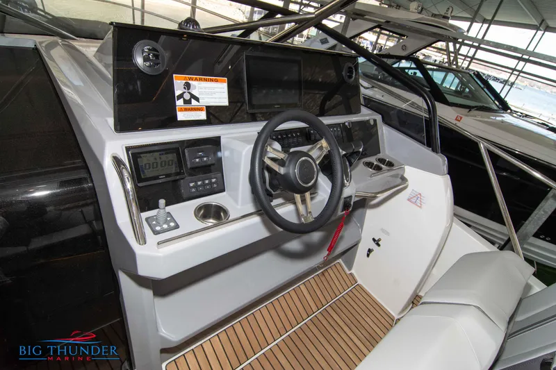 Slide: The Image of 2024 Jeanneau Leader 10.5 WA boat cockpit with steering wheel and control panel. - 33