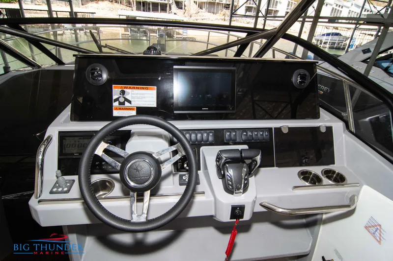Slide: The Image of 2024 Jeanneau Leader 10.5 WA boat dashboard with steering wheel and control panel. - 34