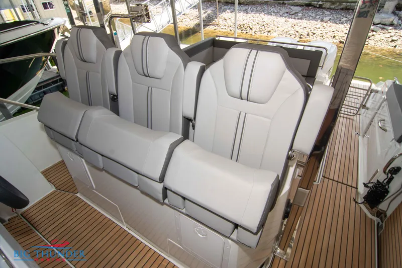 Slide: The Image of 2024 Jeanneau Leader 10.5 WA boat seating area with luxurious gray upholstery. - 44