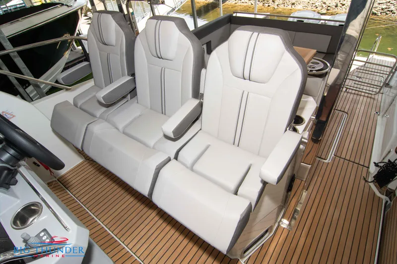 Slide: The Image of 2024 Jeanneau Leader 10.5 WA boat interior with three cushioned seats. - 45
