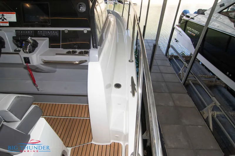 Slide: The Image of 2024 Jeanneau Leader 10.5 WA boat interior with helm station and seating. - 48