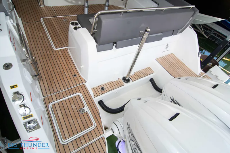 Slide: The Image of 2024 Jeanneau Leader 10.5 WA boat deck with twin outboard engines. - 9