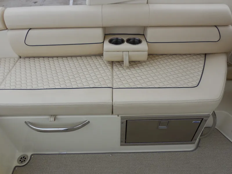 Slide: The Image of 2019 Chris-Craft Launch 28 GT boat interior with beige cushioned seating and cup holders. - 20