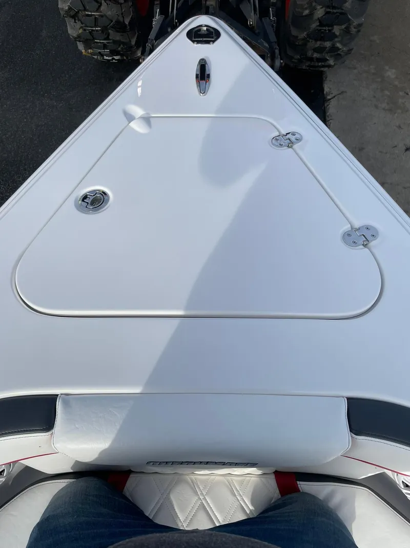 Slide: The Image of 2025 Checkmate Pulsare 2400 BRX boat bow with sleek white design. - 18