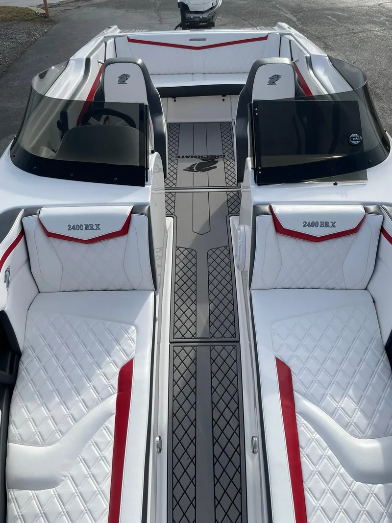 Slide: The Image of 2025 Checkmate Pulsare 2400 BRX boat interior with sleek white and red seating. - 20
