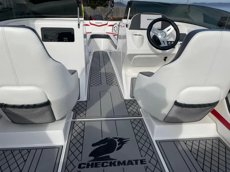 Slide: The Image of Interior of 2025 Checkmate Pulsare 2400 BRX boat with white seating and sleek design. - 24