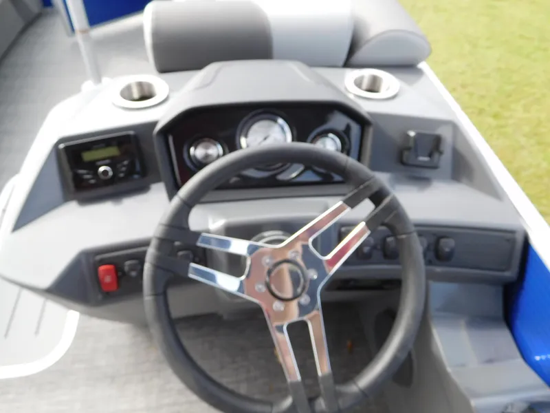 Slide: The Image of 2024 Bennington 20 SVSR boat dashboard with steering wheel and control panel. - 2