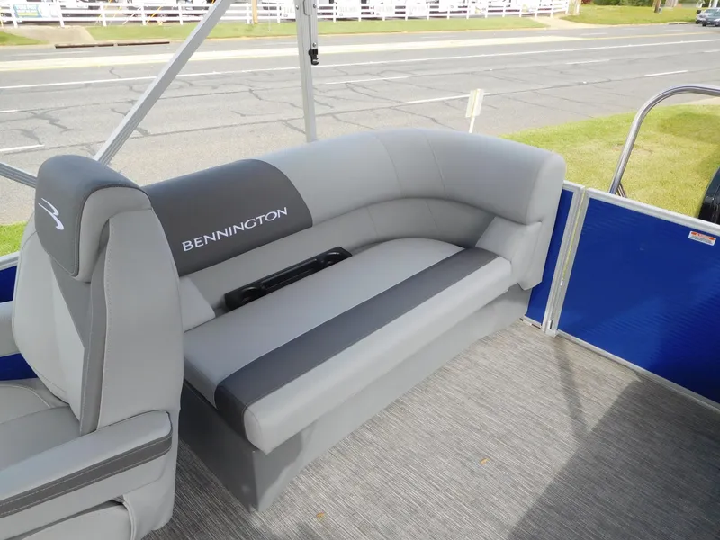 Slide: The Image of 2024 Bennington 20 SVSR pontoon boat with gray seating and blue paneling. - 6