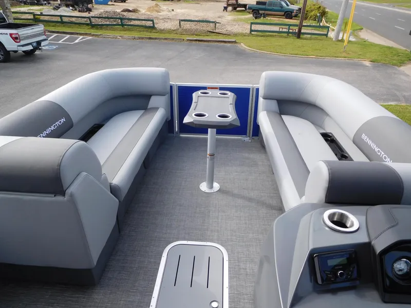 Slide: The Image of 2024 Bennington 20 SVSR pontoon boat interior with gray seating and table. - 7