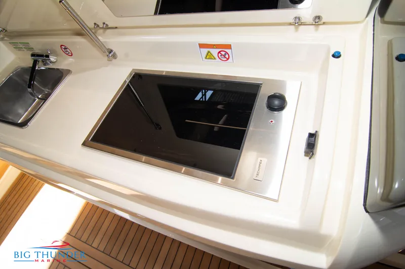 Slide: The Image of 2024 Invictus GT370S yacht kitchen with stove and sink. - 18