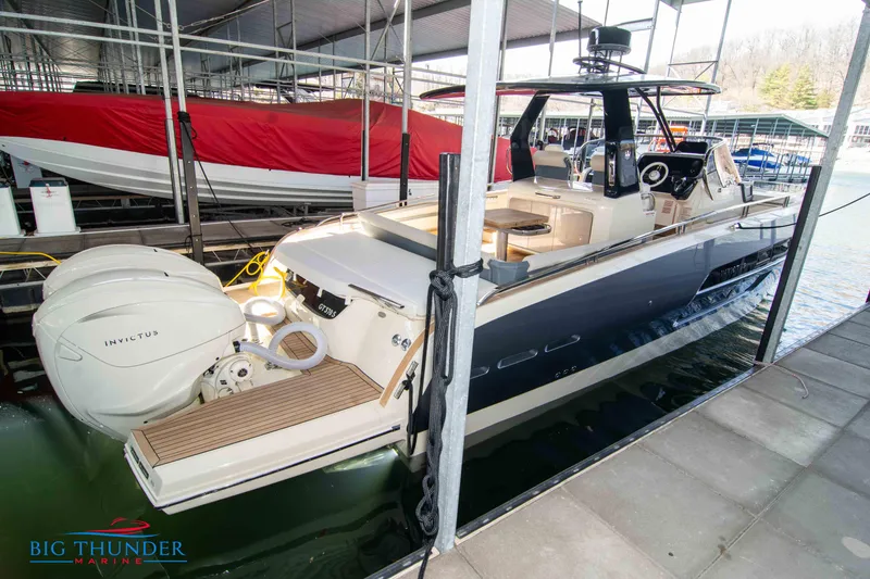 Slide: The Image of 2024 Invictus GT370S luxury yacht docked at Big Thunder Marine. - 2