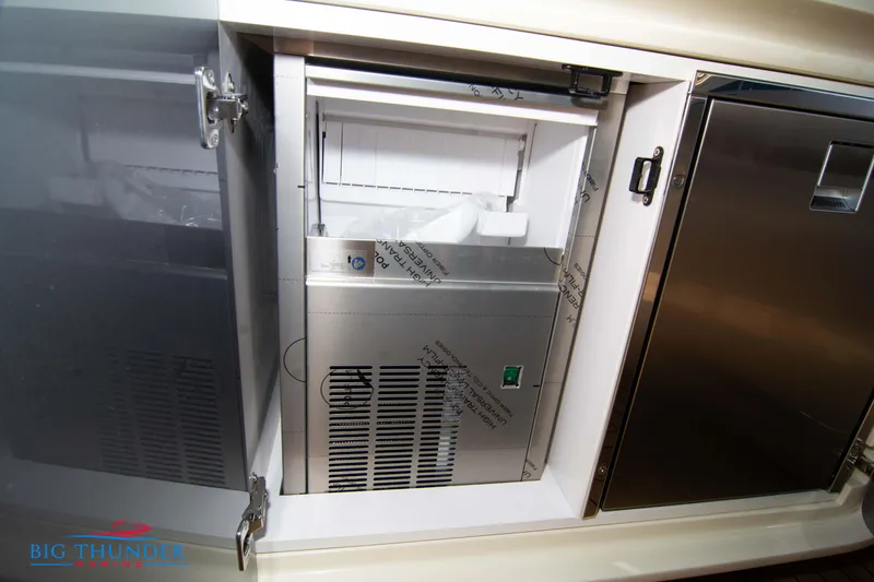 Slide: The Image of 2024 Invictus GT370S yacht interior ice maker and storage compartment. - 20