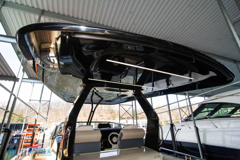 Slide: The Image of 2024 Invictus GT370S luxury yacht under a covered dock. - 22