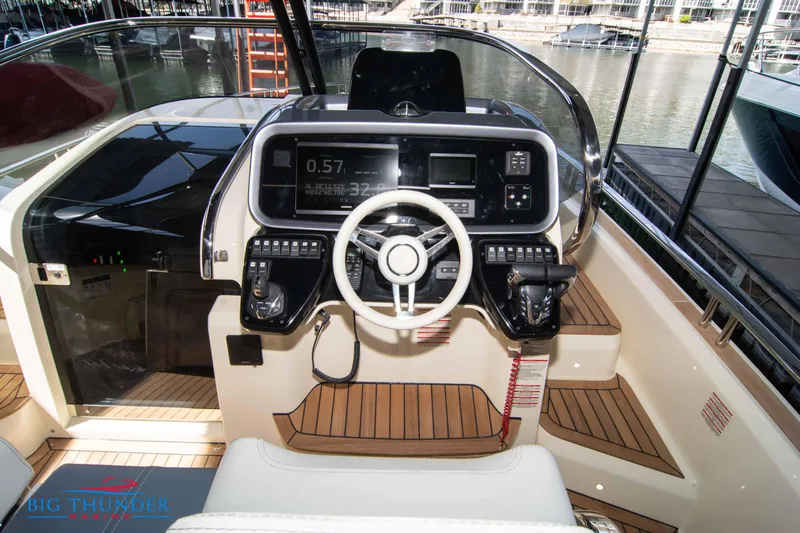 Slide: The Image of 2024 Invictus GT370S boat cockpit with modern steering wheel and control panel. - 23