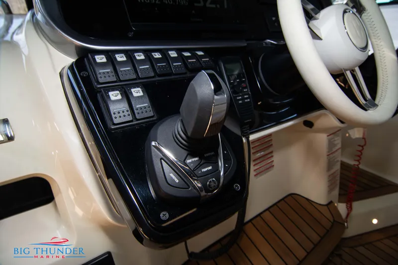 Slide: The Image of Control panel of the 2024 Invictus GT370S boat with joystick and steering wheel. - 36