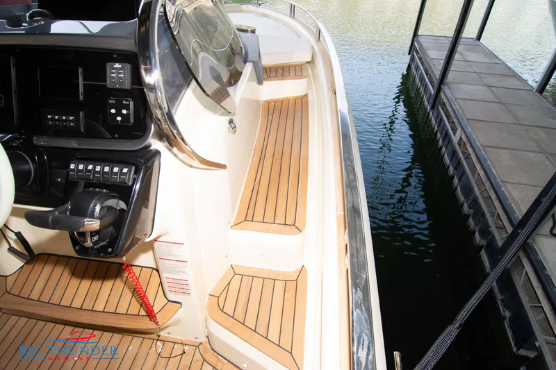 Slide: The Image of 2024 Invictus GT370S boat interior with wooden deck and control panel. - 43
