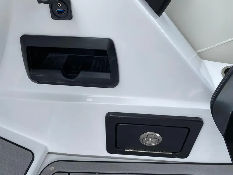 Slide: The Image of 2024 JC Neptoon Sport 23TT DSL boat interior storage compartments and USB port. - 20