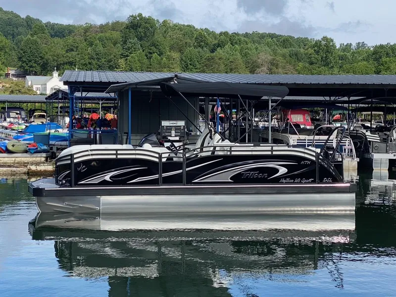 Slide: The Image of 2024 JC Neptoon Sport 23TT DSL pontoon boat docked at a marina. - 3