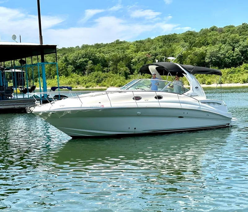 The Image of 2007 Sea Ray 320 Sundancer cruising on a serene lake with lush green surroundings. - 0