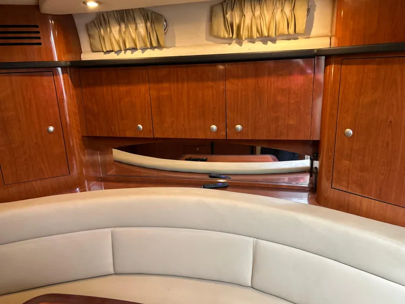 Slide: The Image of Interior of 2007 Sea Ray 320 Sundancer with wood cabinets and beige seating. - 19