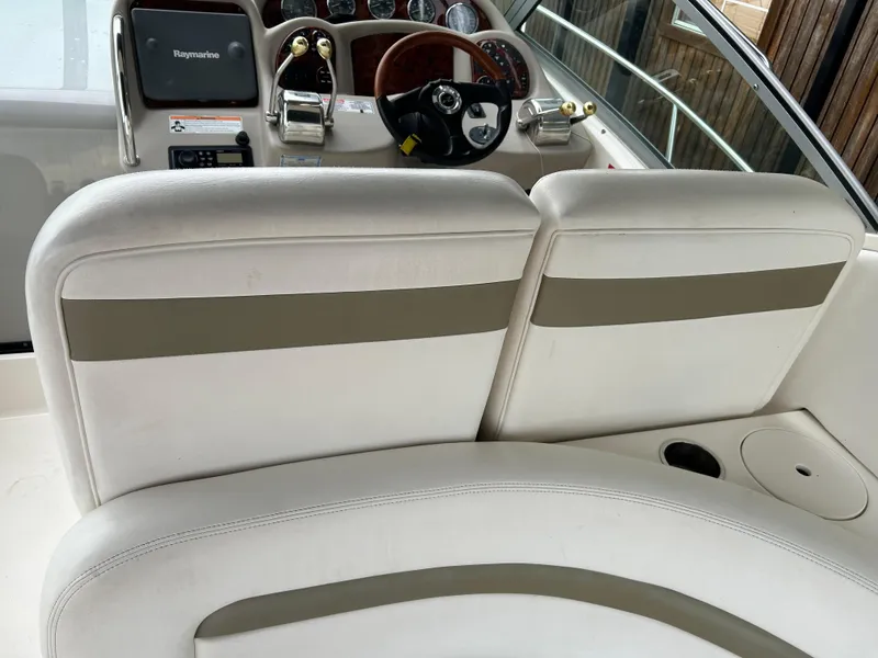 Slide: The Image of 2007 Sea Ray 320 Sundancer cockpit with white seating and modern dashboard controls. - 21