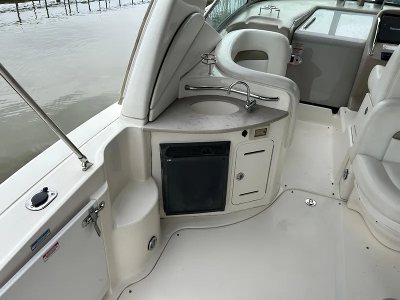 Slide: The Image of 2007 Sea Ray 320 Sundancer boat interior with sink and storage. - 25