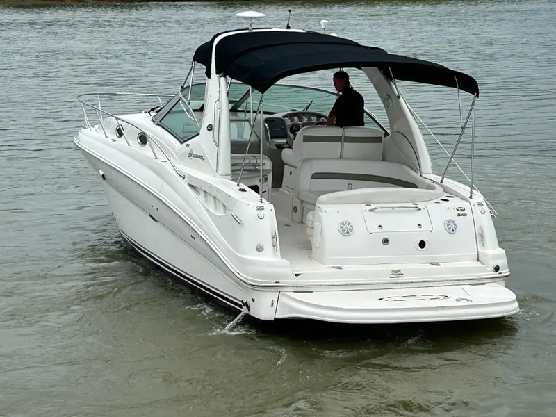 Slide: The Image of 2007 Sea Ray 320 Sundancer boat cruising on calm water with a black canopy. - 27