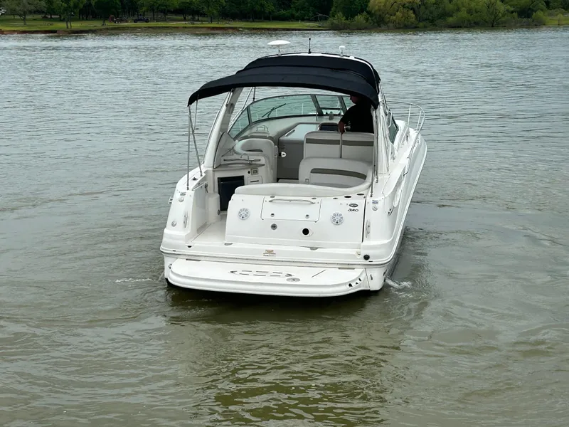 Slide: The Image of 2007 Sea Ray 320 Sundancer boat on calm water, rear view with canopy. - 28