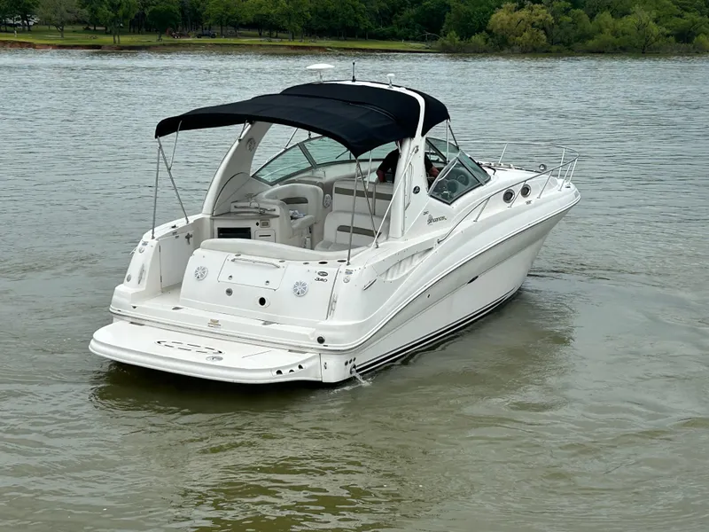 Slide: The Image of 2007 Sea Ray 320 Sundancer boat on calm water with black canopy. - 29