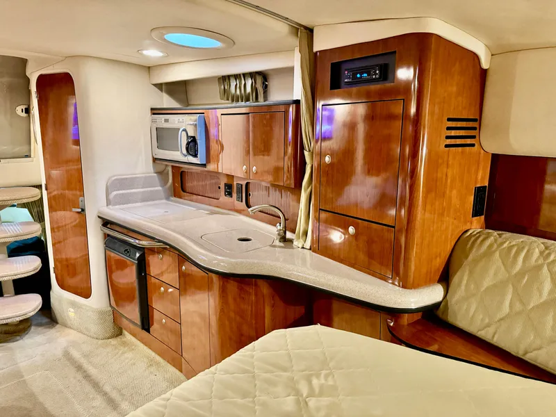 Slide: The Image of Luxurious 2007 Sea Ray 320 Sundancer cabin with kitchenette and wood cabinetry. - 4
